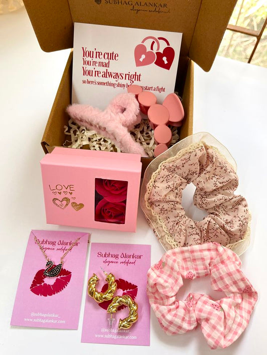Gift set with scrunchies, earrings, and a card on a white surface