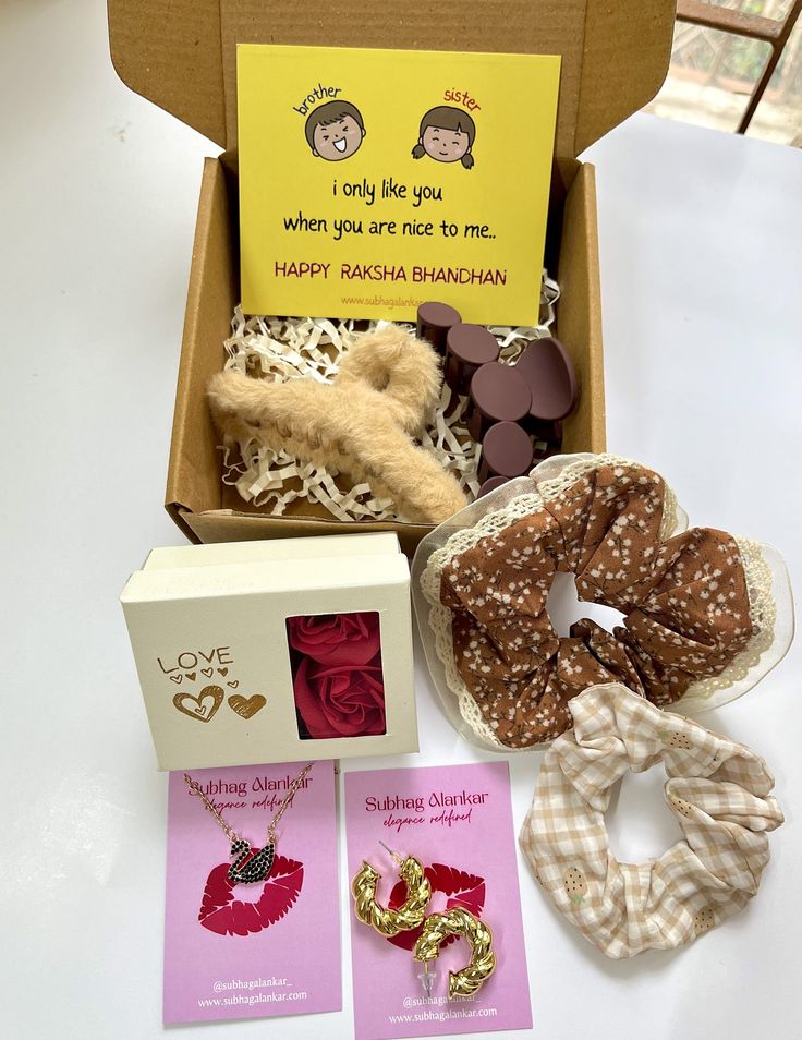 Raksha Bandhan gift set with scrunchies, cards, and other items on a white background